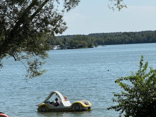 a couple of people in a boat in the water at Ośrodek Wypoczynkowy Świerk in Niewiesze