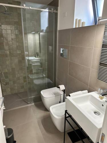 a bathroom with a toilet and a sink and a shower at B&B Case Marcapane in Sommatino