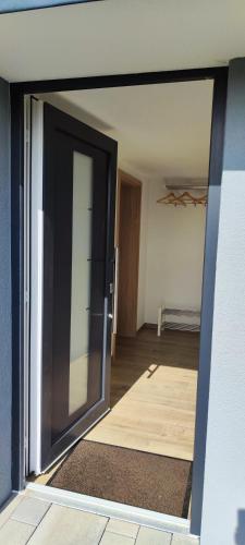 an open glass door of a room with a bedroom at Ferienwohnung Berghaus in Nettersheim
