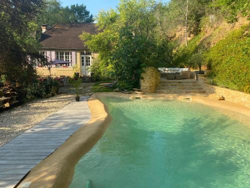 une piscine dans la cour d'une maison dans l'établissement Le lagon des Naïades - Vallée des châteaux, à Daglan