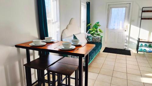a dining room table with cups and saucers on it at Private 4 bedrooms 2 bathrooms Free Parking in Lower Sackville