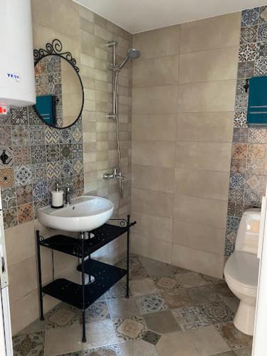 a bathroom with a sink and a toilet at Вила Нелче in Pepelina