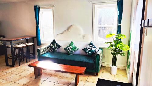 a living room with a green couch and a table at Private 4 bedrooms 2 bathrooms Free Parking in Lower Sackville