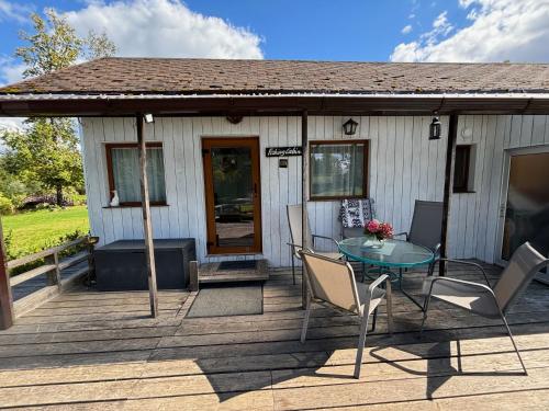 a house with a table and chairs on a deck at Residence R&R in Karvys