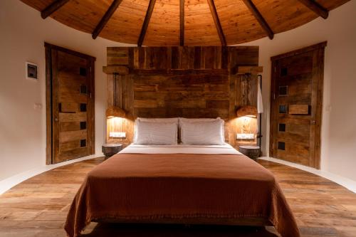 a bedroom with a large bed with wooden walls at Pure Life Göcek in Gökçeovacık