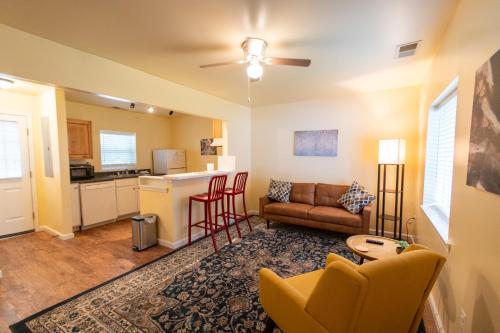a living room with a couch and a kitchen at Howard's Creek Inn in White Sulphur Springs