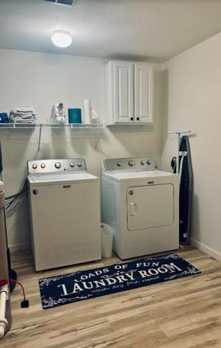 a kitchen with two appliances and a rug on the floor at Lake Ozark's Lakefront Oasis with Fireplace, Game Room, Theater & More! in Osage Beach