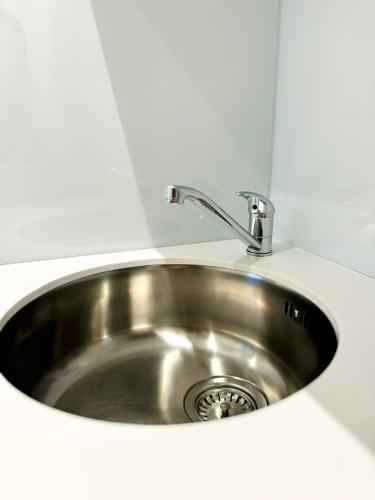 a stainless steel sink in a white counter top at Victoria Studios in London