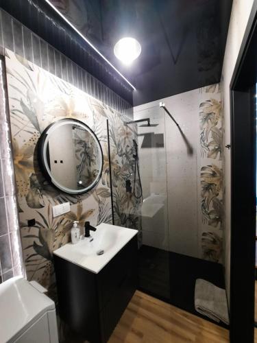 a bathroom with a sink and a mirror at LOCUS SKY TOWER Katowice in Katowice