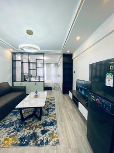 a living room with a couch and a table at Starla Home in Kinoo in Kikuyu