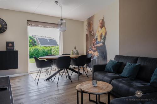 a living room with a couch and a table at Vakantiehuis Noordwijk in Noordwijk