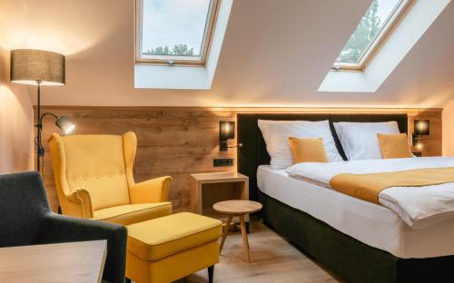 a hotel room with a bed and a chair at Penzion U Mě in Obora