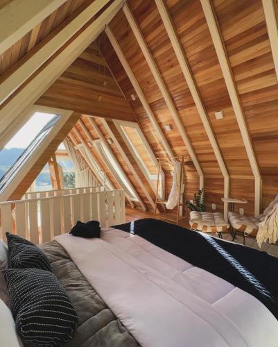 a bedroom with a large bed in an attic at Cabana Snowflake Urubici in Urubici