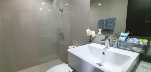 a bathroom with a sink and a toilet and a shower at 2BR at the FORT BGC near Malls, Restaurants & Shops in Manila