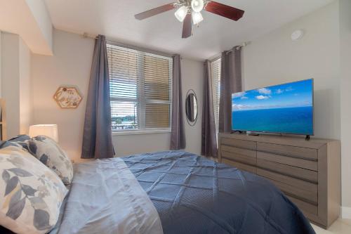 a bedroom with a bed and a flat screen tv at The Relaxing Oasis Suite - Casa Costa 201S 1 Bedroom, Pools, Jacuzzi, Beach, Shops & Dog Friendly in Boynton Beach