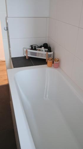 a bathroom with a white tub in a room at Oase Coswig Ferienwohnung in Coswig