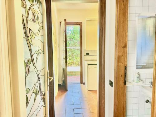 a kitchen with a door open to a bathroom at Forte Classic Stylish Villa in Forte dei Marmi