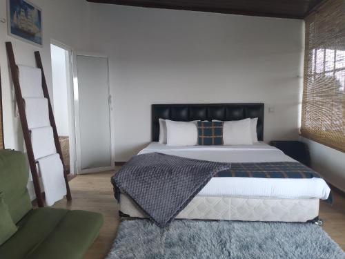 a bedroom with a large bed and a couch at Alakamandava in Colombo