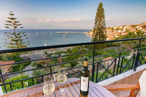 a bottle of wine sitting on a table with wine glasses at Pelagia Apartments in Koroni