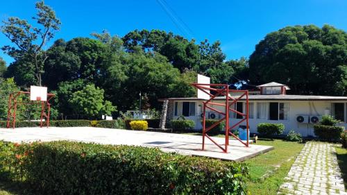a house with a basketball hoop in the yard at Hotel Los Leones in Palenque