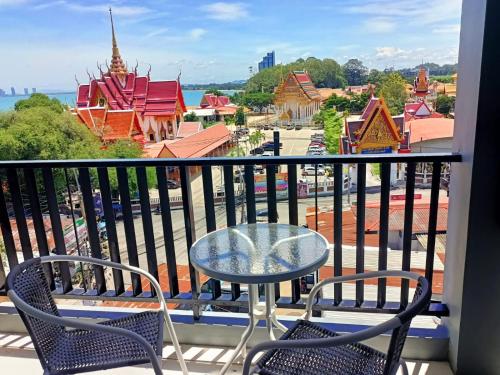 a balcony with a table and chairs and a view of a city at Beach Front Condo Centerviews Bangsaray Floor 6 in Bang Sare