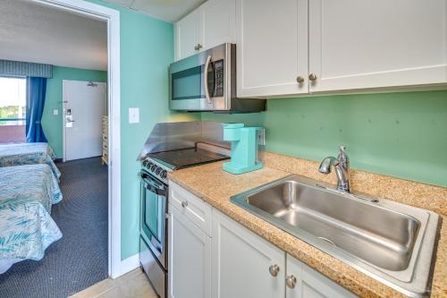 a kitchen with a sink and a counter top at Myrtle Beach Oceanfront Condo w/ Pool & Lazy River in Myrtle Beach