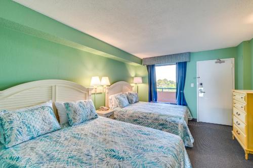a hotel room with two beds and a window at Myrtle Beach Oceanfront Condo w/ Pool & Lazy River in Myrtle Beach