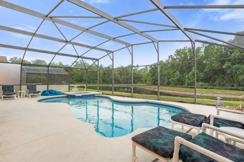 a swimming pool with a pergola and a patio at Upstay Lakeside Retreat w Private Pool and Game Room in Davenport