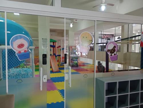 a room with glass doors with hello kitty decorations at Bombinhas Tourist Apart in Bombinhas