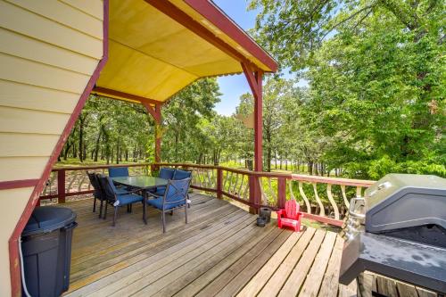 a deck with a table and chairs and a grill at Pet-Friendly McAlester Home with Lake Eufaula Access in McAlester