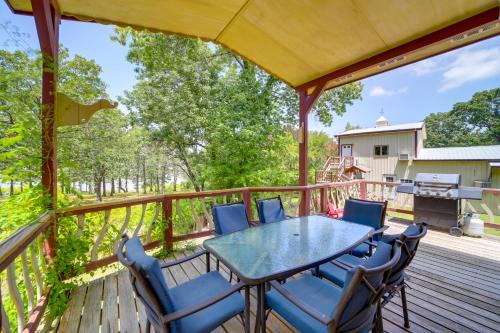 a patio with a table and chairs on a deck at Pet-Friendly McAlester Home with Lake Eufaula Access in McAlester
