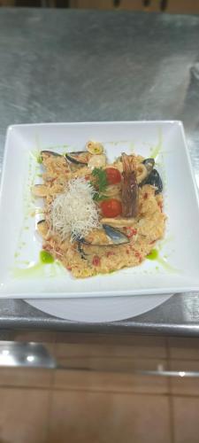 a white plate of food on a table at LA CASONA DE PALMIRA in Caín