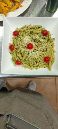 a plate of pasta and tomatoes on a table at LA CASONA DE PALMIRA in Caín