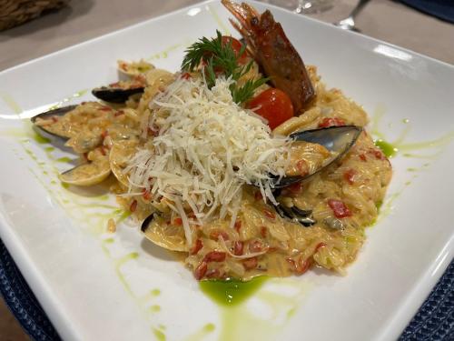 a white plate of food with pasta and cheese at LA CASONA DE PALMIRA in Caín