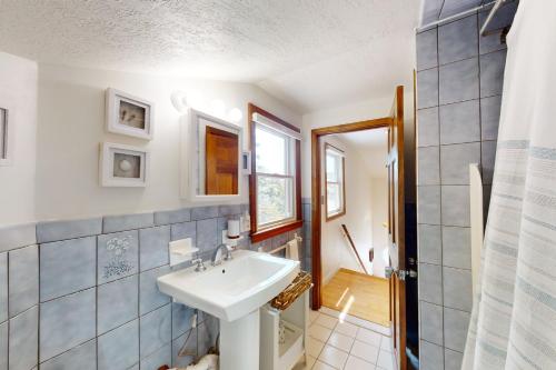 a bathroom with a white sink and a shower at Osprey's Nest in West Hyannisport