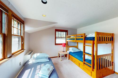 a bedroom with two bunk beds and a desk at Osprey's Nest in West Hyannisport