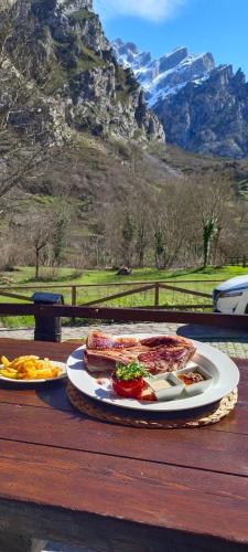 a sandwich on a plate on a table with food at LA CASONA DE PALMIRA in Caín