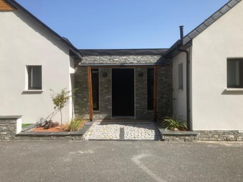 a house with a front door and a driveway at Le chalet Paula in Agos-Vidalos