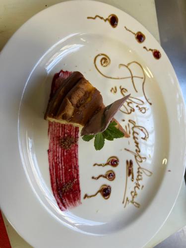 a white plate with a piece of food on it at LA CASONA DE PALMIRA in Caín