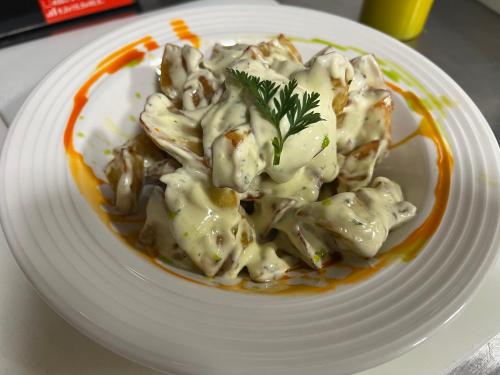 a white plate of food with dumplings on it at LA CASONA DE PALMIRA in Caín