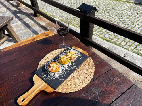 a table with a plate of food and a glass of wine at LA CASONA DE PALMIRA in Caín