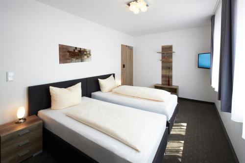 מיטה או מיטות בחדר ב-Hotel New In Guesthouse