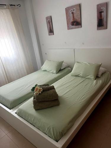 two beds sitting next to each other in a room at La Casa Rosita, Hacienda Riquelme Golf Resort Sucina in Murcia