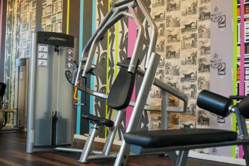 a gym with two tread machines in front of a wall at Crowne Plaza Antwerpen by IHG in Antwerp