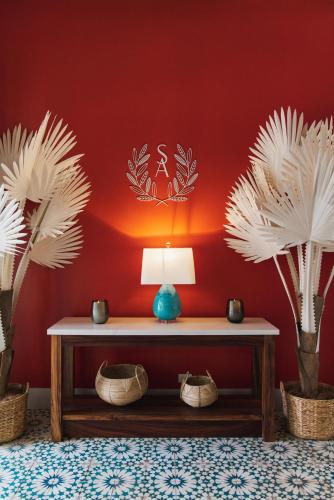a room with a table with a lamp and two palm trees at Santarena Hotel at Las Catalinas in Playa Flamingo