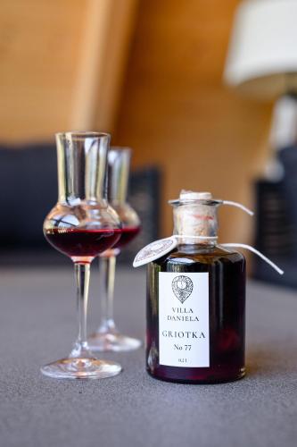 a bottle of wine next to a glass of wine at Villa Daniela in Úvaly