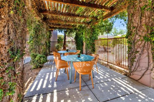 a table and chairs sitting under a pergola at Lodge On The Desert in Tucson