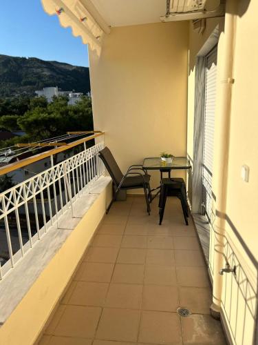 a balcony with a table and chairs on it at Elxie House in Xanthi