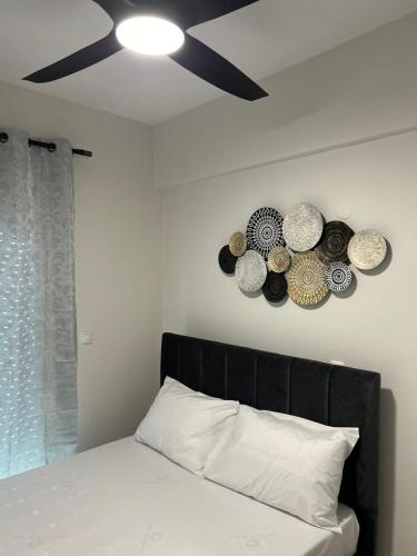 a bedroom with a bed with a ceiling fan at Elxie House in Xanthi
