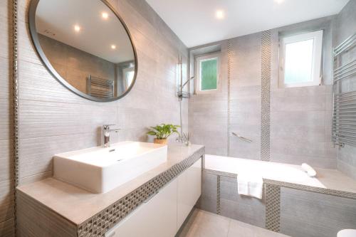 a bathroom with a sink and a mirror at Blue City apartments in Trenčín